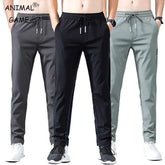 Men's slim fit breathable pencil pants with drawstring in black, gray, and light gray colors, styled as casual trousers.