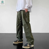 Men wearing olive green waterproof cargo pants with adjustable drawstring and multiple pockets for outdoor use