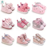 Selection of nine pairs of Baby Princess Fashion First Walkers Shoes in various pink shades with butterfly knot and stylish designs for infants 0-12 months.