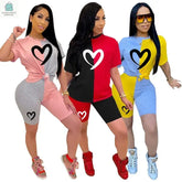 Three women wearing colorful casual slim fit patchwork tracksuits with short sleeves and heart designs