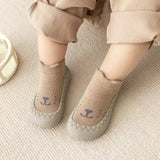 Cute cartoon baby socks shoes with slip-on design and soft cotton fabric for infants and toddlers.