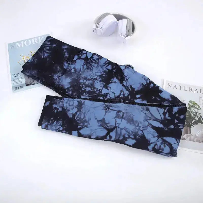 Upgrade your yoga wardrobe with our Women's Seamless Tie Dye Yoga Pants, designed for comfort and style. These ankle-length leggings feature a soft and stretchy span