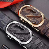 Two premium leather men belts with stylish patterned design and distinctive metal buckles, one with a gold-tone buckle and the other with a silver-tone buckle.