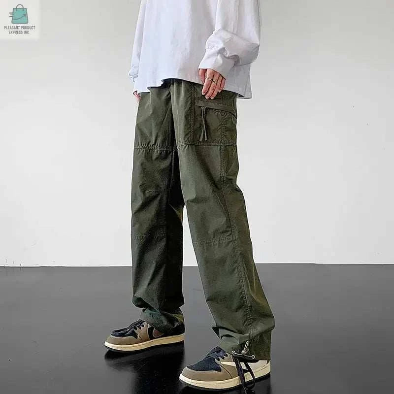 Men wearing olive green waterproof cargo pants with adjustable drawstring and multiple pockets for outdoor use