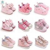 Selection of nine pairs of Baby Princess Fashion First Walkers Shoes in various pink shades with butterfly knot and stylish designs for infants 0-12 months.