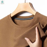 Men's brown summer waffle short sleeved cotton t-shirt with round neck on wooden hanger.