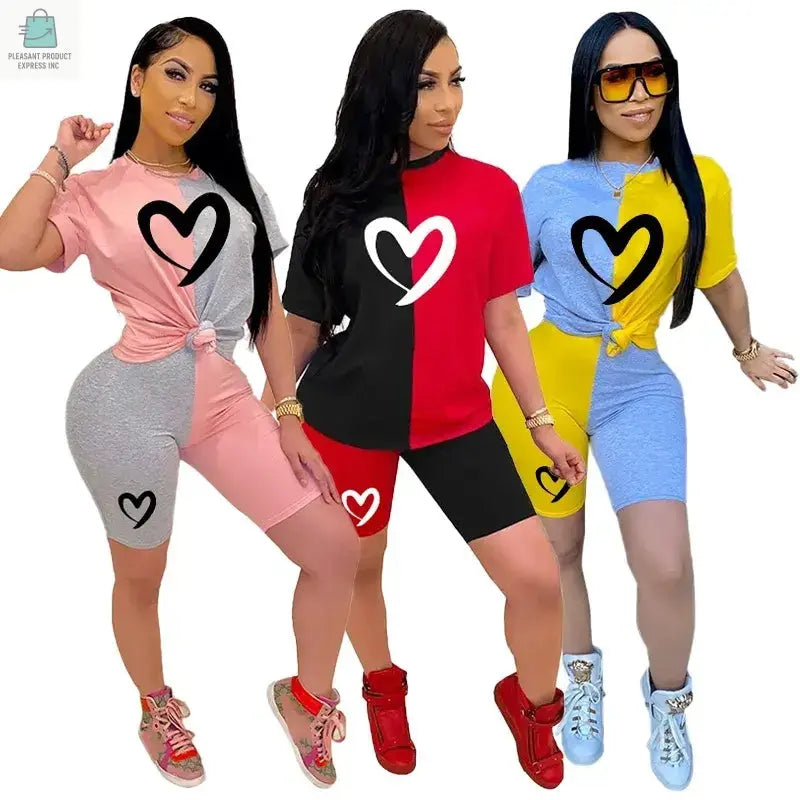 Three women wearing colorful casual slim fit patchwork tracksuits with short sleeves and heart designs