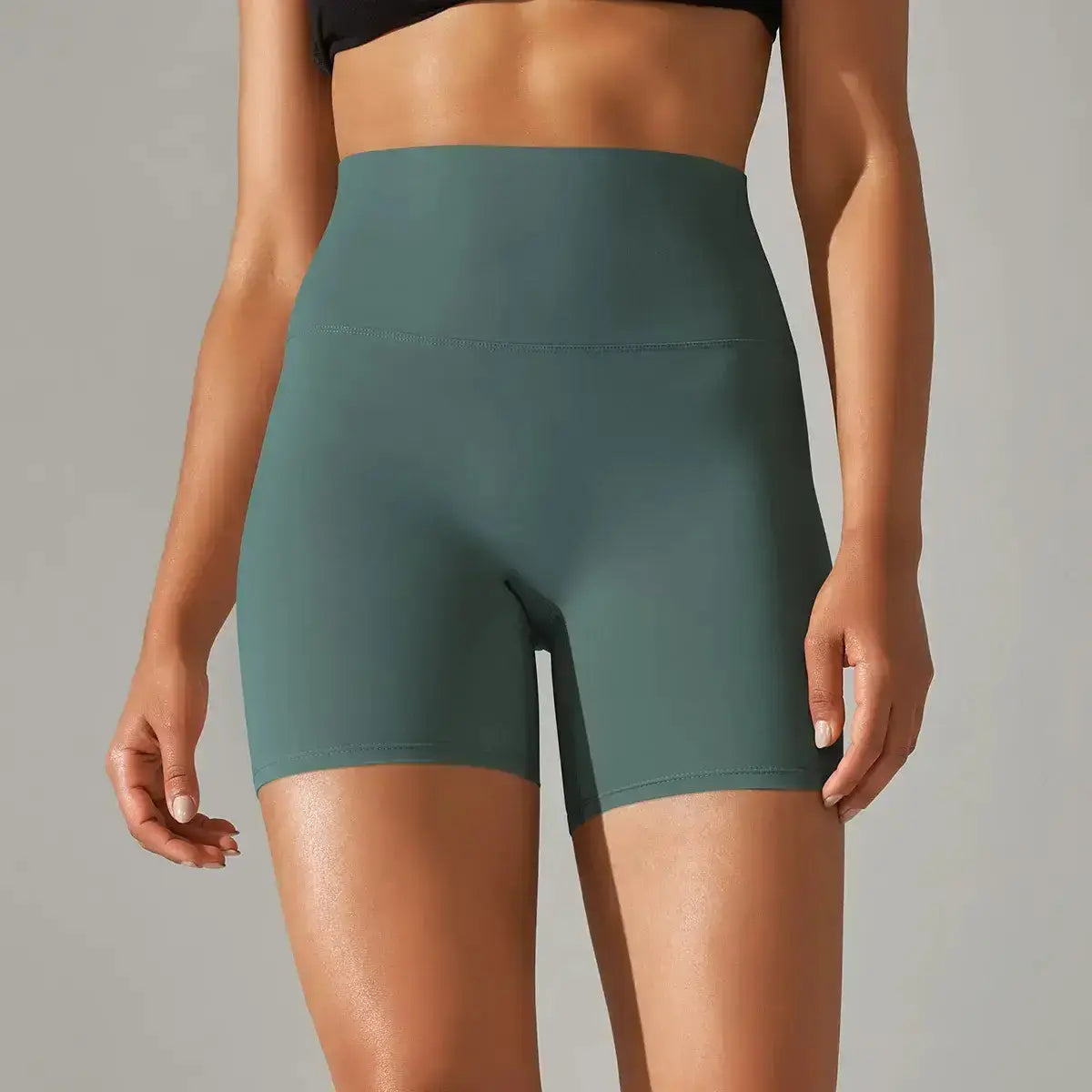 woman wearing high-waisted green comfortable and stylish yoga shorts for fitness activities